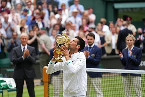 Serbia's Novak Djokovic kisses the winner's trophy after his victory over Italy's Matteo Berrettini during the men's singles final match on day thirteen of the Wimbledon. (Photo | AP)