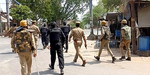 Police personnel in action after violence erupted during the block panchayat chief polling, in Etawah. (Photo| ANI)