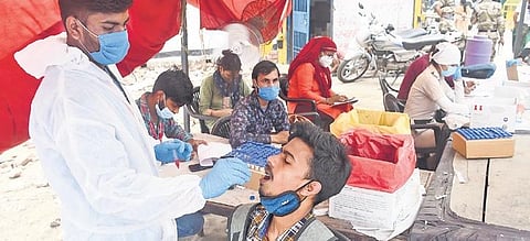 A medic collects swab sample for Covid testing in Delhi on Monday | Parveen Negi