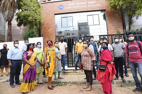 Parents gather outside Jain Heritage School in Bengaluru on Monday | Express