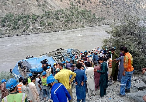 Local residents and rescue workers gather at the site of bus accident, in Kohistan Kohistan district of Pakistan (Photo | AP)