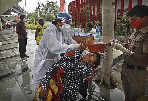 A health worker takes nasal sample of a man for COVID-19 test near a metro station, in New Delhi, India, Tuesday, July 13, 2021. (Photo | PTI)