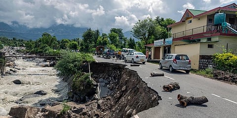 A damaged road due to flash flood after heavy rain at Sheela village near Dharamshala. (Photo | PTI)