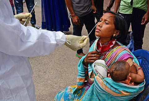A health worker collects swab samples of a woman in Bengaluru on Monday | Shriram BN