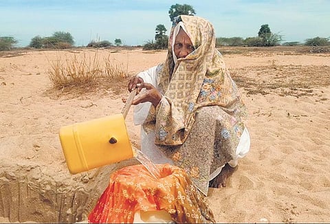 Women from the village come once in a day to fetch water from the sand-springs using a makeshift ladle | Express