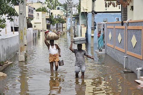 As many localities in the city remain waterlogged, residents of Ayyappa Colony in Bandalguda shift their belongings on Friday. (Photo | Vinay Madapu, EPS)