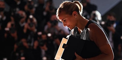 French director Julia Ducournau poses with her trophy during a photocall after she won the Palme d'Or for the film 'Titane' at Cannes. (Photo | AFP)