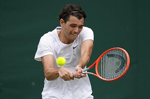 Taylor Fritz of the US plays a return to Steve Johnson of the US during the men's singles second round match on day four of the Wimbledon Tennis Championships. (Photo | AP)