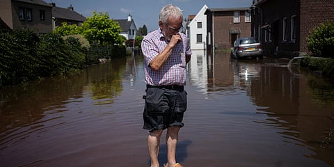 A senior citizen stands outside his flooded home in the town of Brommelen, Netherlands. (Photo| AP)