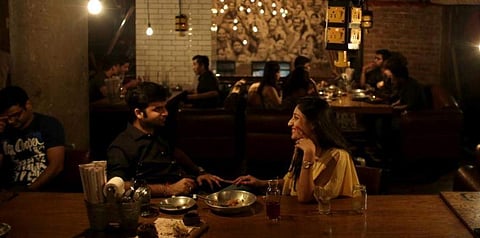 In this representational file photo, a couple shares dinner at Social, a three-story destination on the edge of Hauz Khas Village in Delhi. (File photo | AP)