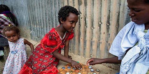 Elena, 7, left, plays a game of checkers using soda bottle tops with friend Hailemariam, 12, at a reception and day center for displaced Tigrayans in Mekele, in Ethiopia's Tigray region. (Photo | AP)