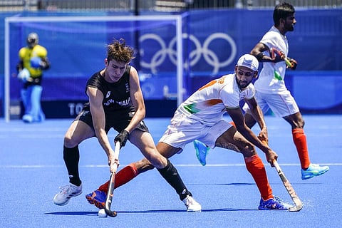 New Zealand's Sean Findlay, left, and India's Mandeep Singh, right, vie for the ball during a men's field hockey match at the 2020 Summer Olympics. (Photo | AP)