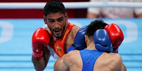 India's Ashish Kumar (L) exchanges punches with China's Tuoheta Erbieke during their men's middleweight 75-kg boxing match at the 2020 Summer Olympics in Tokyo, Japan. (Photo | AP)