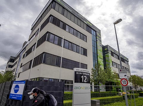 In this May 6, 2021 file photo a man with a face mask leaves the headquarters of the German biotechnology company 'BioNTech' in Mainz, Germany. (Photo | AP)