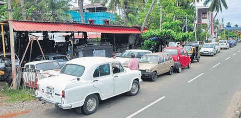 Cars queued up in front of a workshop in Enchakkal |B P Deepu