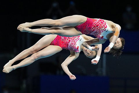 Yuxi Chen and Jiaqi Zhang of China compete during the women's synchronized 10m platform diving final at the Tokyo Aquatics Centre at the 2020 Summer Olympics. (Photo | AP)