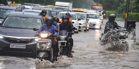 Vehicles ply on the waterlogged Ring Road during monsoon rains, in New Delhi on Tuesday. (Photo | ANI)