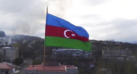 Azerbaijan's national flag with the city of Shushi in the background, in the separatist region of Nagorno-Karabakh. File photo | AP)