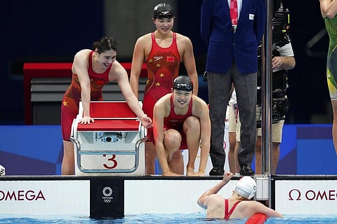 China's women's 4x200-meter freestyle relay team celebrate after winning the gold medal in the final at the 2020 Summer Olympics. (Photo | AFP)