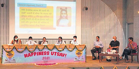 Deputy CM Manish Sisodia and others listen as students share their experiences about Happiness Curriculum in government schools at a function on Friday. (Photo | EPS)