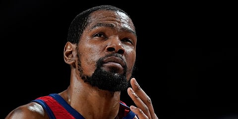 US' Kevin Durant reacts after he collided with another player and hit his face during a men's basketball preliminary round game against the Czech Republic at the 2020 Olympics in Saitama. (Photo | AP)