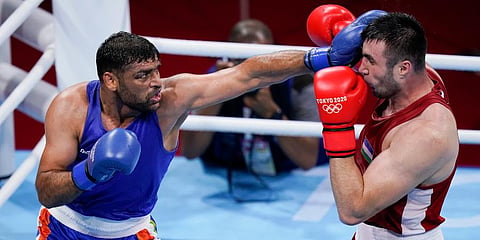 India's Satish Kumar (L) punches Uzbekistan's Bakhodir Jalolov during their men's super heavyweight over 91-kg boxing match at the 2020 Summer Olympics in Tokyo, Japan. (Photo | AP)