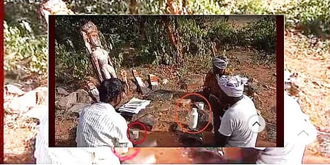 A screen grab of the three Chenchu men placing land-related documents in front of the deity and praying for the protection of their village