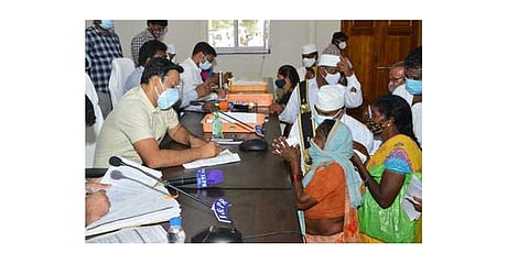 Collector Praveen Kumar receiving a grievance from a complainant | express