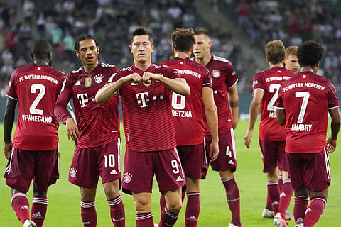 Bayern's Robert Lewandowski, center, celebrates after scoring first goal during Bundesliga match against Borussia Moenchengladbach on Friday, Aug. 13, 2021. (Photo | AP)