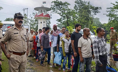 Image of people queued up at a detention centre used for representational purposes
