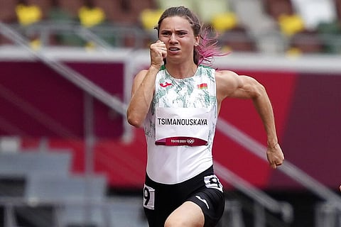 Krystsina Tsimanouskaya, of Belarus, runs in the women's 100-meter run at the 2020 Summer Olympics. (Photo | AP)