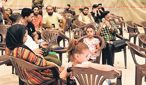 People evacuated from Afghanistan rest after landing at Hindon air base on Sunday. (Photo | EPS)