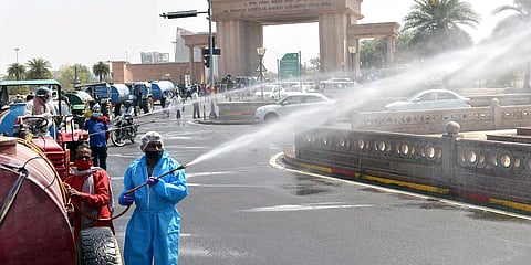 File photo fo civic workers spraying disinfectant during the weekend lockdown. (ANI)