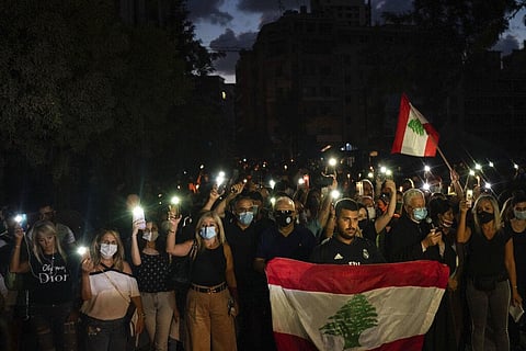 Demonstrators march holding candles and flashlights honoring the victims of the deadly explosion at Beirut port which devastated large parts of the capital. (File Photo | AP)