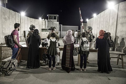 Soldiers with the 82nd Airborne Division check evacuees during an evacuation at Hamid Karzai International Airport. (Photo | AP)