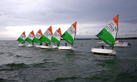 Participants with tri colour sailboats compete in the National level Multi Class Youth Sailing Championship organised by Madras Engineers Group (MEG) of Indian Army at KRS reservoir. | Uday Shankar S