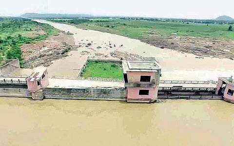 Water flows out of the Kadam project after officials lifted three gates. (Photo | Express)