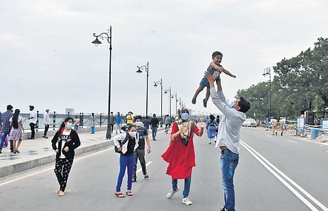 A family enjoying their time at Tank Bund Road as vehicles were diverted from the 2-km stretch on Sunday. (Photo | S senbagapandiyan)