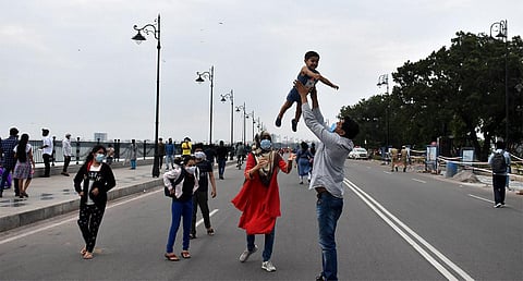 A family enjoying their time at Tank Bund Road as vehicles were diverted from the 2-km stretch on Sunday. (Photo | S senbagapandiyan)