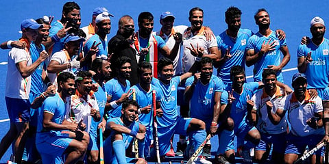 Members of the India team pose for photographs after defeating Germany 5-4 during the men's field hockey bronze medal match at the 2020 Summer Olympics in Tokyo, Japan. (Photo | AP)