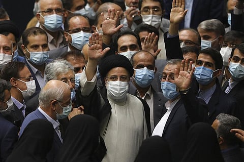 President Ebrahim Raisi, center, waves to journalists as he is surrounded by group of lawmakers after taking his oath as president at the parliament in Tehran, Iran. (Photo | AP)