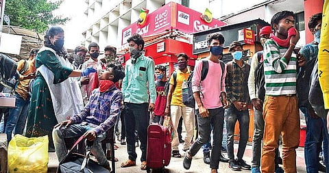 A health worker collects swab samples of a passenger at Krantivira Sangolli Rayanna railway station in Bengaluru on Wednesday | Shriram BN