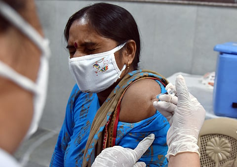 A healthcare worker inoculates a dose of the COVID-19 vaccine to a beneficiary, in New Delhi. (Photo | ANI)