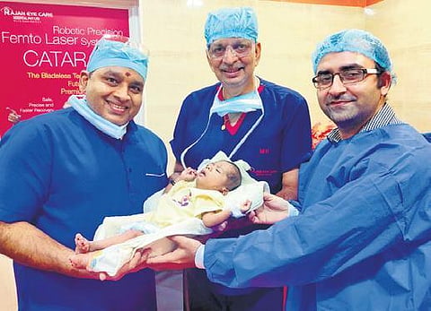 Dr Mohan Rajan (centre) and team with the premature baby