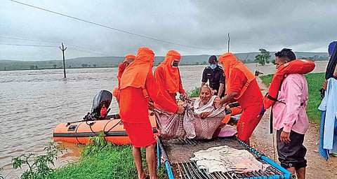 NDRF personnel rescuing an elderly woman from one of the flood affected districts of Gwalior-Chambal region of Madhya Pradesh | special arrangement