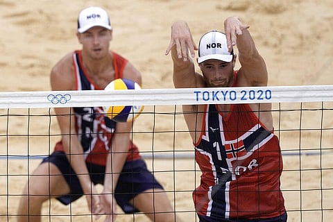 Anders Berntsen Mol, right, of Norway, and teammate Christian Sandlie Sorum, compete during a men's beach volleyball Gold Medal match. (Photo | AP)