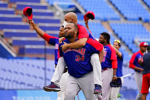 Dominican Republic's Juan Ramon Francisco Gonzalez, front and Raul Valdes, celebrate after the bronze medal baseball game against South Korea. (Photo | AP)