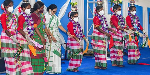 West Bengal CM Mamata Banerjee with people belonging to tribal communities during an event on the occasion of International Day of the World's Indigenous Peoples, in Jhargram district. (Photo | PTI)