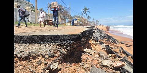People carrying luggage walking along the Thiruvananthapuram airport- Shankhumukham road which was damaged in sea attacks | B P Deepu