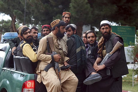 Taliban fighters arrive inside the Hamid Karzai International Airport after the U.S. military's withdrawal, in Kabul, Afghanistan. (Photo | AP)